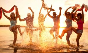 Large group of young people enjoying a beach party